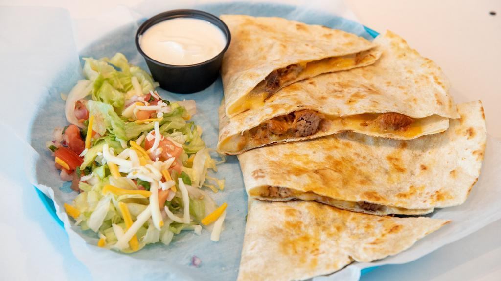 Quesadilla With Carnitas · Cheesy heaven. Flour tortilla, carnitas, and mixed cheese. Served with a side of homemade salsa, authentic Mexican crema, and pico de gallo. Add guacamole for an additional charge.