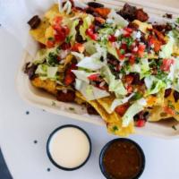 Nachos With Carnitas · A large pile of corn tortilla chips, carnitas, beans, and cheese sauce. Served with a side o...