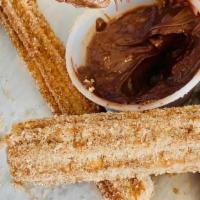 Mexican Churros & Nutella · Fried dough topped with cinnamon sugar . served with a side of chocolate creamy nutella.