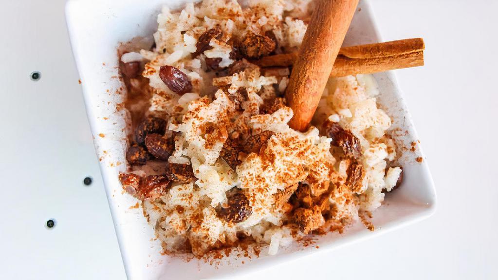 Vegan Rice Pudding · All plant base  rice pudding (almond milk, rice, cinnamon and vanilla) topped with cinnamon powder and raisins.