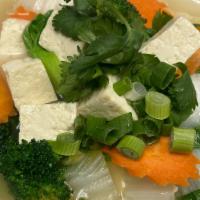 Tofu Soup · Tofu, leafy greens, green onions and cabbage in savory broth.