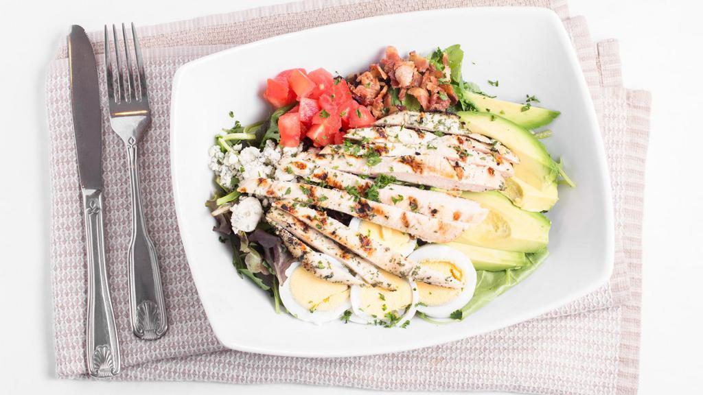 Café Cobb · Field greens, grilled chicken, avocado, applewood smoked bacon, tomato, hard cooked eggs, Bleu cheese.