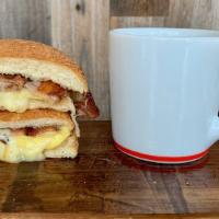 The Egg & Cheese Sandwich · scrambled egg and Vermont white cheddar cheese on our toasted house English muffin …add baco...