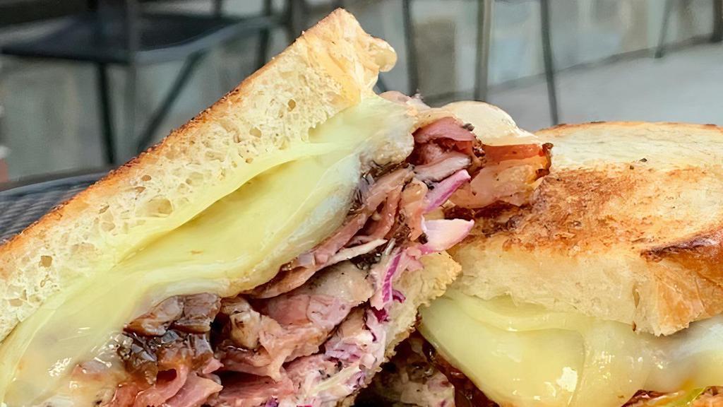 Ruebenesque Sandwich · Sautéed navel pastrami, melted swiss cheese, caramelized red onions, house slaw and hot sauce on toasted sourdough... we love a good rueben, but this is special.