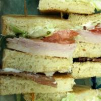 Club Sandwich · Choice of bread, mayo, lettuce, tomato, bacon, American cheese, turkey, & ham.