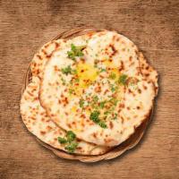 Buttery Delight Naan · Leavened white bread baked in tandoor oven with butter.