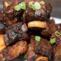 Jerk Rib Tips · Jerked Rib bites quickly fried and tossed with Jerk BBq sauce and served with sweet plantain.