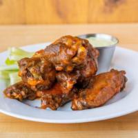 Traditional (Bone-In) Wings · Marinated and soft poached chicken wings fried to crispy perfection and tossed with the sauc...