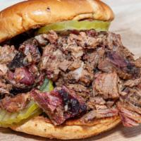 Chopped Brisket Sandwich · Our delicious prime slow smoked brisket chopped, and tossed in our beer BBQ sauce. Topped wi...