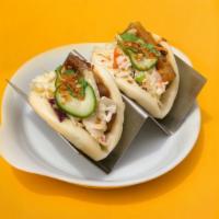 Pork Belly Bao · Hoisin BBQ garlic chip, cilantro. Includes cabbage slaw, and pickled cucumber.