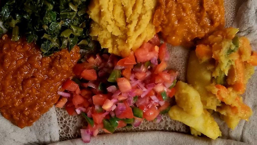 Vegetarian Combo #2 · Combinations of Shiro, potato & carrots, lentil, split peas spinach & tomato salad served with Injera or Bread