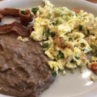 Huevos A La Mexicana · Eggs scrambled with onions, tomato and jalapeno peppers.