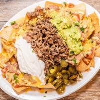 Nachos Omg · Tortilla chips topped with chile con queso, refried beans, pico de gallo, jalapenos, sour cr...