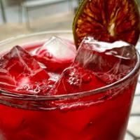 Hibiscus Iced Tea · Our house made hibiscus iced tea with lime and honey!