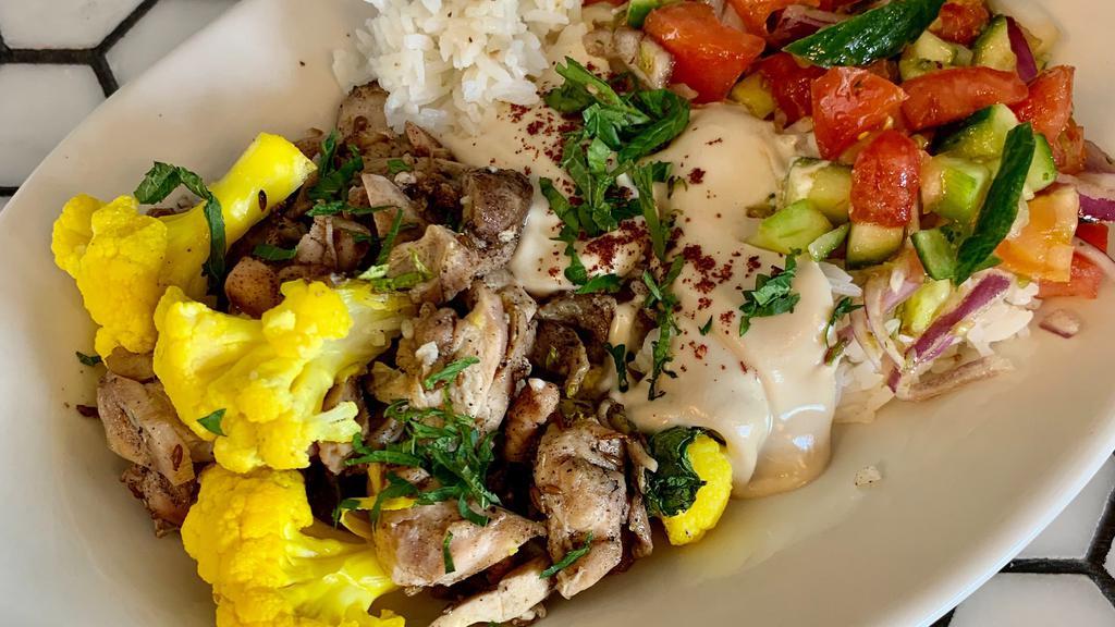 Chicken Shawarma Plate · free range marinated grilled chicken w/ pickled cauliflower, israeli pickles, grilled onions, arabic salad, served over jasmine rice with tahini