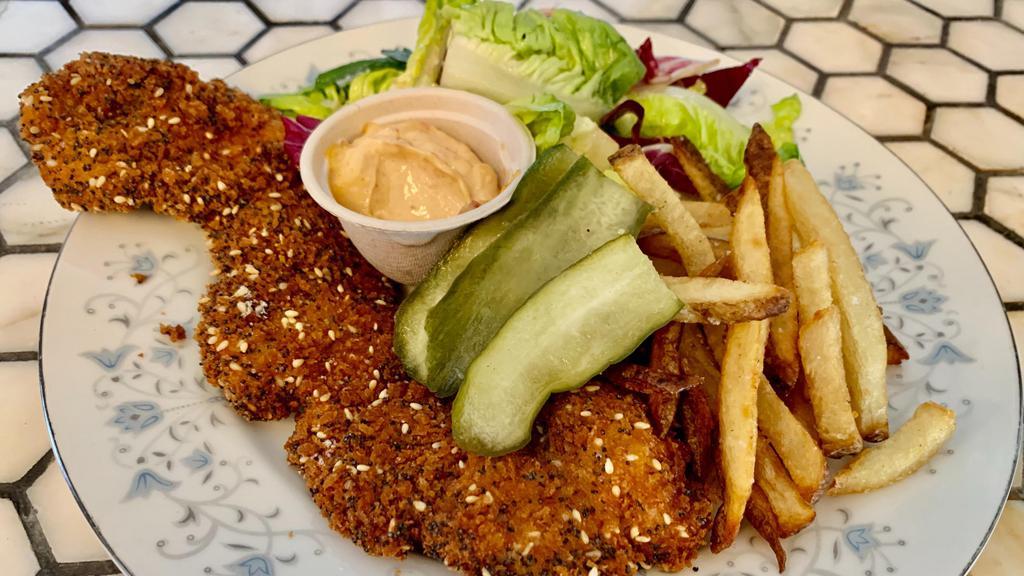 Schnitzel Plate · sesame crusted free range chicken, served with french fries and romaine chopped salad with tomato, israeli pickles, lemon vinaigrette & dijon mustard
