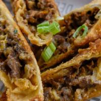 Ghost Cheesesteak Eggrolls · House made egg rolls stuffed with shaved Ribeye, caramelized onion, beer whiz and American c...