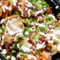 Loaded Waffle Fries · Seasoned waffle fries, Monterey jack, chopped bacon, herb ranch and scallions