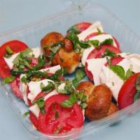Caprese Salad · Sliced tomatoes, fresh mozzarella, basil and balsamic vinaigrette.
