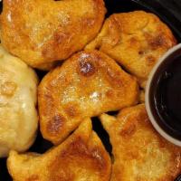 Pot Stickers (6) · Pan-fried chicken dumplings filled with green onions.