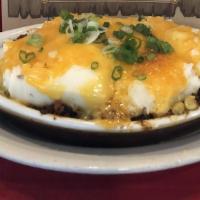 Shepherd'S Pie · We start with a layer of refried beans, Texas chili, Jalapeno corn, mashed potatoes, cheddar...