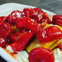 Strawberry Sopaipillas · Deep fried Mexican pastry sprinkled with powdered sugar and cinnamon, surrounded with whippe...