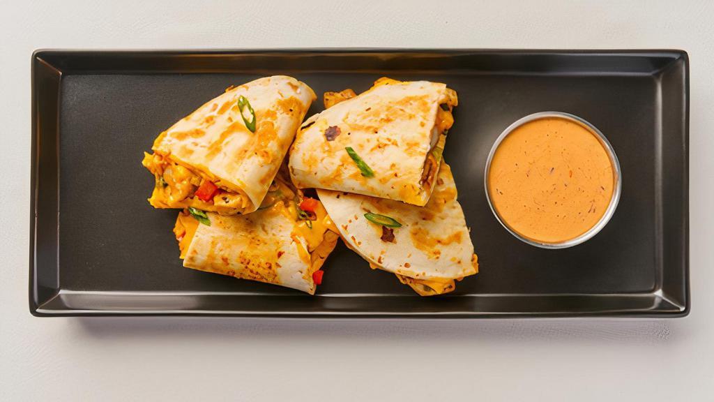 Teriyaki Quesadilla · NEW! Mixture of cheeses, teriyaki chicken and roasted peppers in a grilled flour tortilla, served with house-made Chili-Crisp Ranch.