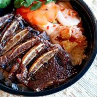 Korean Bbq · Grilled short ribs marinated in lemongrass with a side of kimchi.
