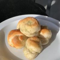 Garlic Knots (4 Pieces) · Homemade pizza dough twisted in knots with our award winning garlic sauce. Voted best knots ...