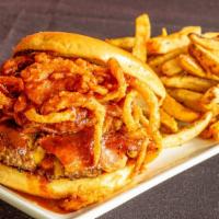 Rodeo Burger · 8 oz all-beef patty topped with onion strings, house seasoned bacon, cheddar cheese and hous...