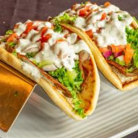 Gyros · Greek spiced lamb & beef on pita bread with lettuce, tomato, red onion, cucumber and house-m...
