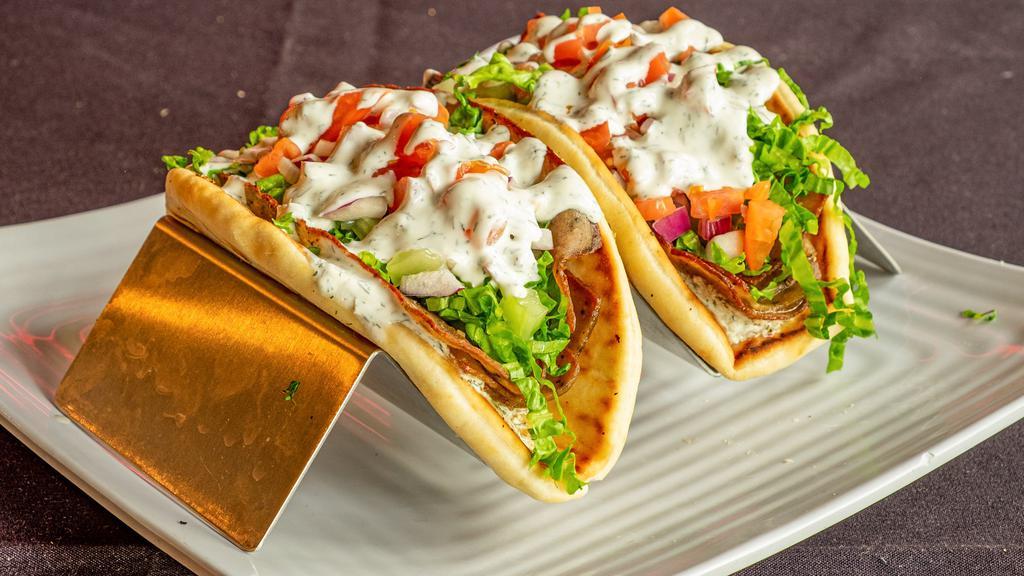Gyros · Greek spiced lamb & beef on pita bread with lettuce, tomato, red onion, cucumber and house-made tzatziki sauce.