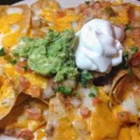Nachos · Corn chips topped with refried beans, melted cheese, in a light tomato-tomatillo sauce, pico...