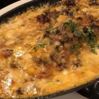 Queso Fundido (Fondue) · A blend of melted cheeses with stir fried pico de gallo.
