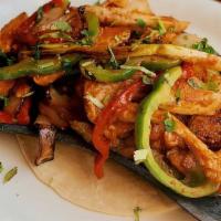 Fajitas De Pollo · Marinated chicken breast, stir fried with green chiles, bell peppers, cilantro, onions & tom...