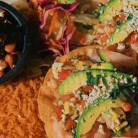 Tostadas Acapulco Style · Crisp corn tortillas topped with chilled diced shrimp, langostino, tilapia calamari & avocad...