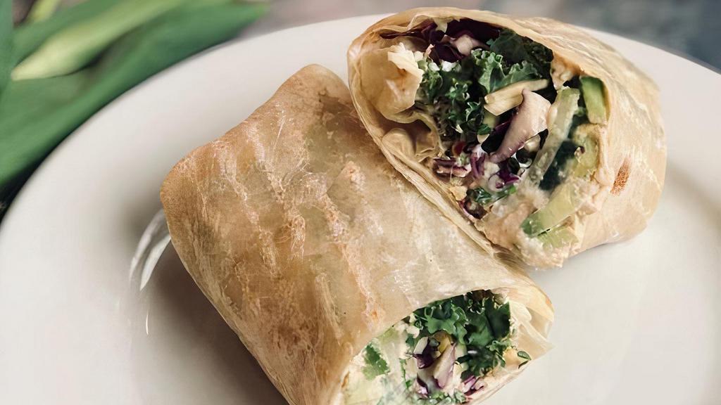 Hummus Wrap · Garlic hummus, avocado, cucumber, sprouts, kale, cabbage, carrots, tahini sauce and chipotle hot sauce wrapped in a flour tortilla. 
add tempeh or tofu $2.95