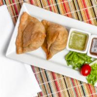 Samosa · Vegetable turnovers stuffed with potatoes and green peas, tempered with cumin seeds and spic...