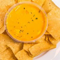 Chile Con Queso · Creamy mix of melted cheese and pico de gallo served with homemade chips.
Add ground beef or...