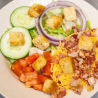 Deluxe Salad · Crisp lettuce mixed with shredded carrots & cabbage topped with cheddar cheese, bacon bits, ...