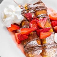 Nutella Crepe · Nutella, bananas and strawberries topped with whipped cream and powdered sugar.