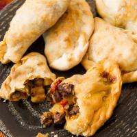 Beef Empanada Traditional · Ground beef, onions, and spices.