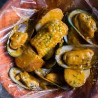 New Zealand Green Mussels (1 Lb) · Served with corn and potatoes and a choice of sauce.