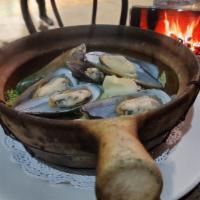 Clay Pot Mussels · With fresh herbs: lemon grass, basil and lime leaves served in a clay pot with spicy chili-g...