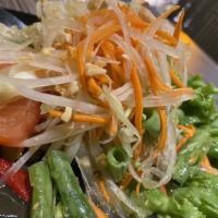 Green Papaya Salad · Spicy. Shredded green papaya with spicy lime dressing and ground peanuts.