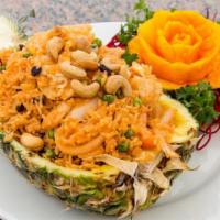 Pineapple Fried Rice · Sautéed rice with chicken, shrimp, pineapple, cashew nuts, and raisins served in a pineapple...