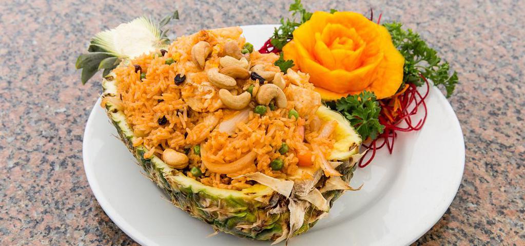 Pineapple Fried Rice · Sautéed rice with chicken, shrimp, pineapple, cashew nuts, and raisins served in a pineapple shell.