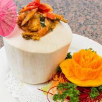 Red Curry In A Coconut (Hor-Mok) · Spicy. Sea scallops, shrimp and calamari in an egg red curry sauce served in a fresh coconut.