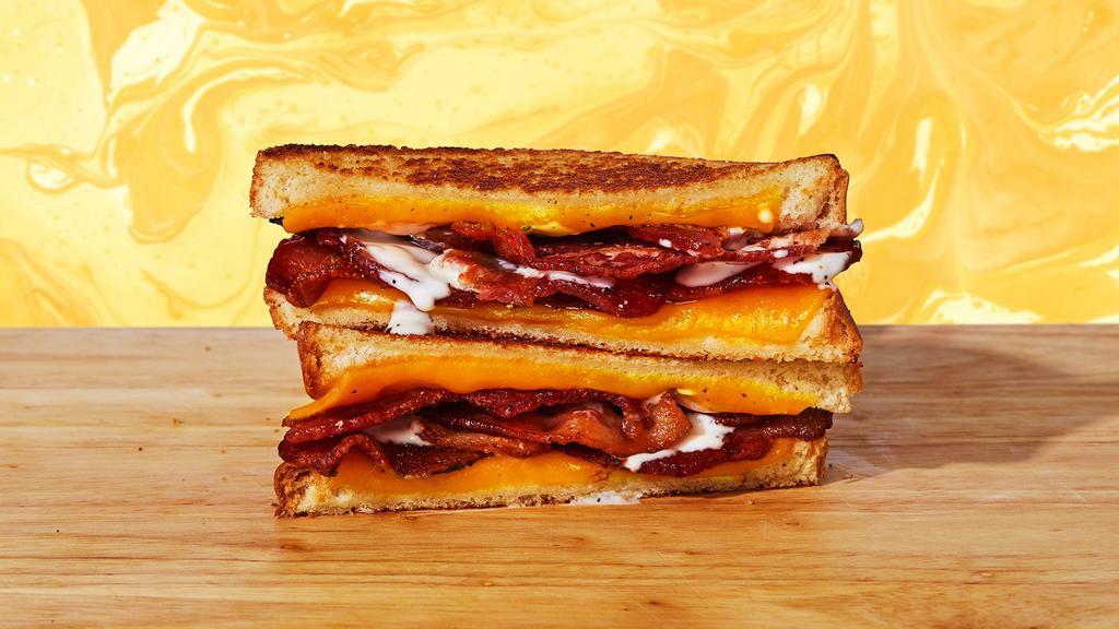 Bacon Cheddar Ranch Grilled Cheese · Melted cheddar, crisp bacon, and ranch dressing between two sliced of buttery grilled bread.