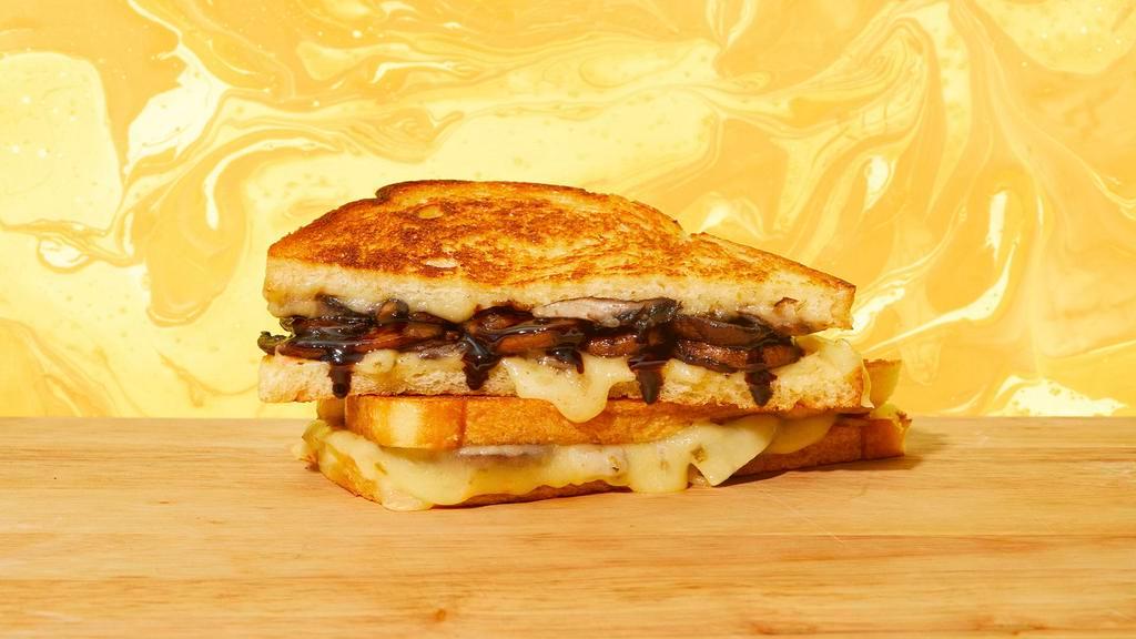 Mushroom Grilled Cheese · Melted swiss cheese, roasted mushrooms, caramelized onions, balsamic vinegar, and mayo between two slices of buttery grilled bread.